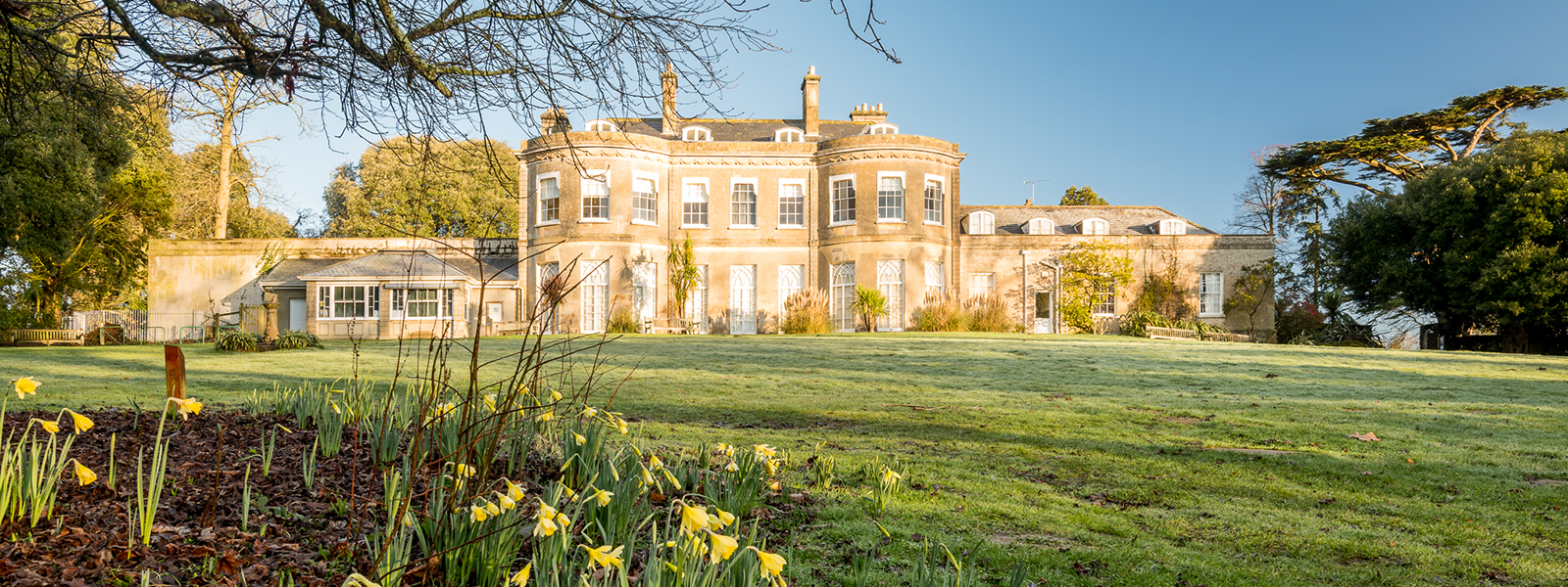 South side of Upton House with daffodils