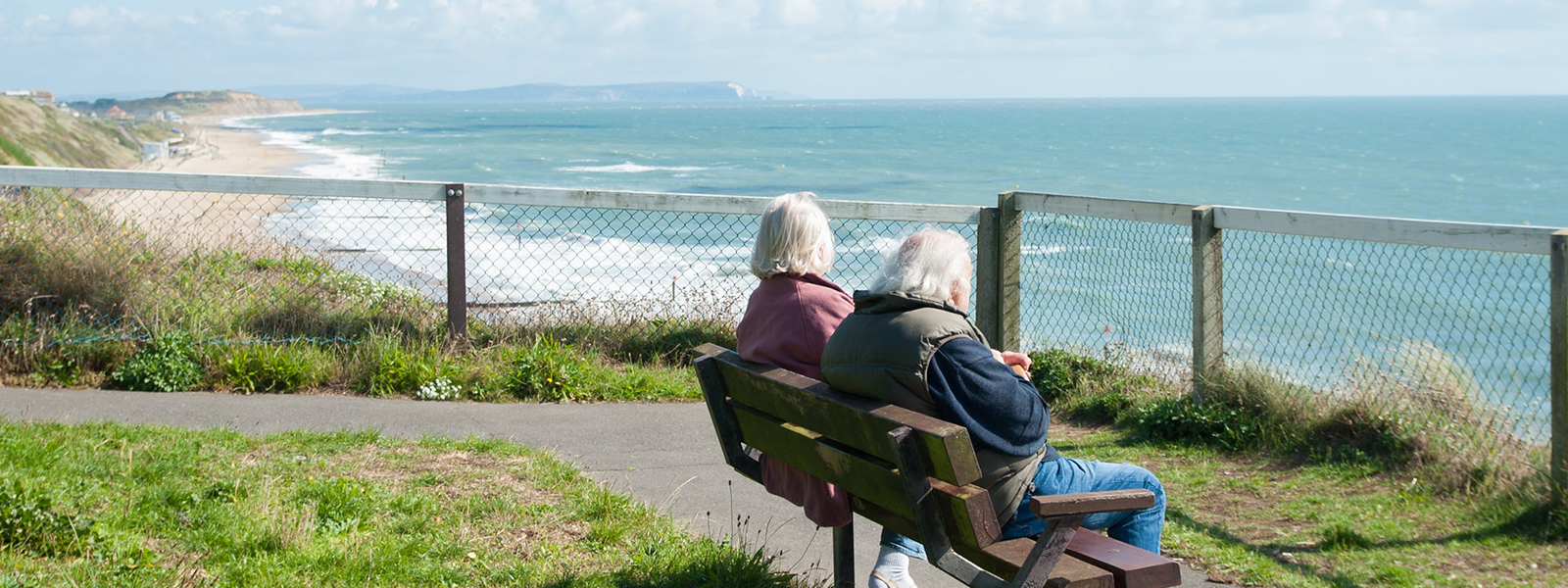 Couple on a bench overlooking the sea