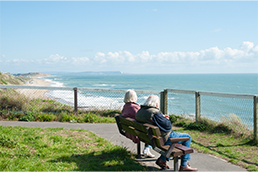 couple on a bench overlooking the sea