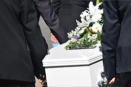 Coffin and pall bearers