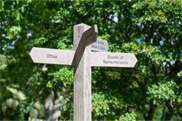 Wooden signpost in cemetery